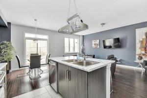 a kitchen with a sink and a counter top at Modern townhome in Kanata w direct forest access in Ottawa