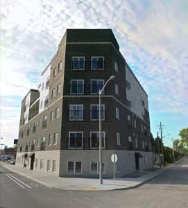 a building on the corner of a street with a street light at High-end condo downtown Kingston near RMC Queens in Kingston