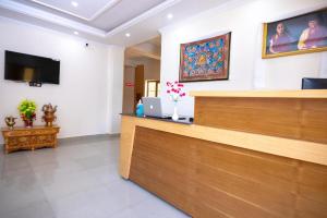 a waiting room with a reception desk and a flat screen tv at The Nangsay Hotel in Leh