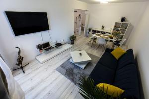 a living room with a couch and a table at West Marina Aparthotel Cluj in Floreşti