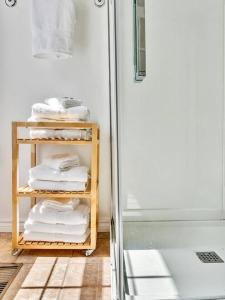 a bathroom with a rack of towels and a shower at The Gem - Beautiful farmhouse with hot tub in West Lake