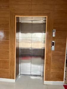 a large metal elevator in a building at The Nangsay Hotel in Leh