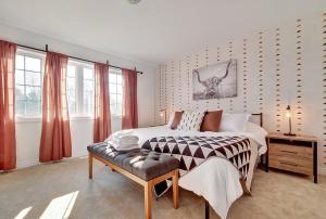 1 dormitorio con cama, mesa y ventanas en Spacious newly built PEC family home, en Carrying Place