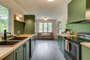 a kitchen with green cabinets and a wooden floor at Family chalet in the heart of Wakefield in Wakefield