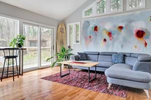 a living room with a blue couch and a table at La Hacienda - Edelweiss après-ski - wooded escape in Val des Monts