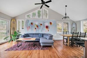 a living room with a blue couch and a table at La Hacienda - Edelweiss après-ski - wooded escape in Val des Monts