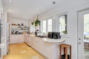 a kitchen with white cabinets and a counter top at Century home by river hot tub & parking in Ottawa