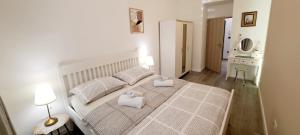 a bedroom with a bed with two towels on it at A&Z APARTMENT in Zagreb