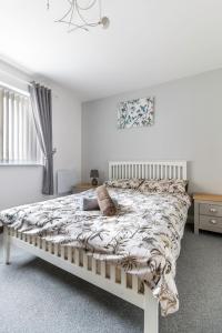 a white bedroom with a bed with a blanket at 2 Bedroom Flat, Glasshoughton in Castleford