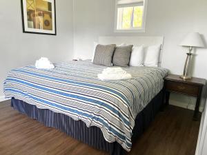a bedroom with a large bed with two towels on it at The Picton: Beautiful Couple's Getaway in PEC in Wellington