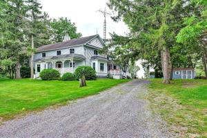 a large white house with a gravel driveway at The Highway House - PEC Waterview Getaway in Wellington
