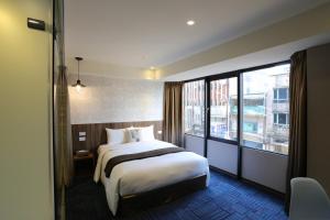 Postel nebo postele na pokoji v ubytování Ark Hotel - Changan Fuxing方舟商業股份有限公司