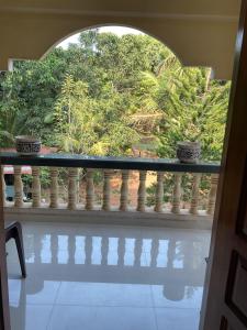 a balcony with a view of a garden at Grace Air-conditioned Cool Homestay in Benaulim