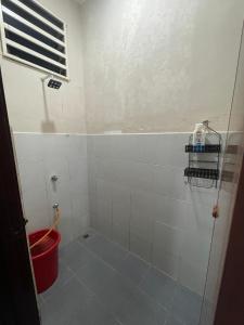 a bathroom with a shower with a bucket in it at Irdina Homestay Beserah, Kuantan in Kuantan