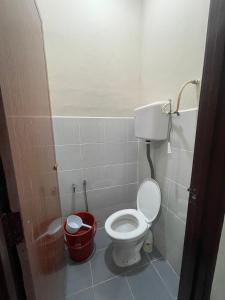 a bathroom with a toilet and a trash can at Irdina Homestay Beserah, Kuantan in Kuantan