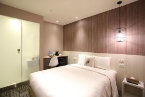 Postel nebo postele na pokoji v ubytování Ark Hotel - Changan Fuxing方舟商業股份有限公司