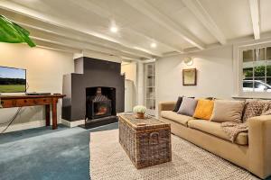 a living room with a couch and a fireplace at Blackwood Tree Cottage Heritage Listed Evandale in Evandale