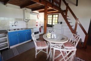 a kitchen with a table and chairs in a kitchen at Casa Mar in Burgau