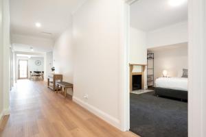 a white bedroom with a bed and a dining room at Renovated Delight in Invermay in Invermay
