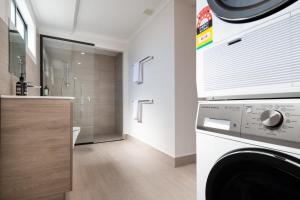a bathroom with a washer and dryer in a room at Renovated Delight in Invermay in Invermay