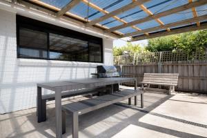 a picnic table and a grill on a patio at Renovated Delight in Invermay in Invermay