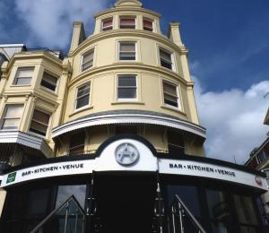 a building with a clock on the front of it at Amsterdam Hotel Brighton in Brighton & Hove