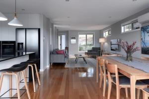 a kitchen and living room with a table and chairs at Breathtaking Views with Parking in Trevallyn in Inveresk