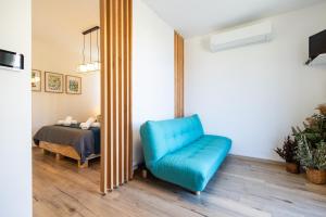a blue chair in a room with a bed at Luxury home A Casuzza con Jacuzzi vicina al mare in Casteldaccia