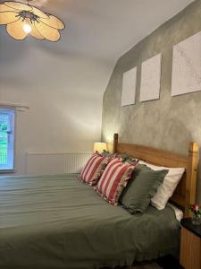 a bedroom with a bed with pillows on it at Rosie Cottage in Ashbourne