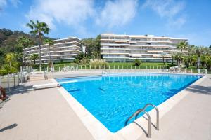 a swimming pool in front of a building at Magnifique vue mer panoramique in Vallauris