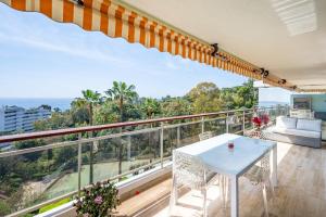 a view from the balcony of a house with a table and chairs at Magnifique vue mer panoramique in Vallauris