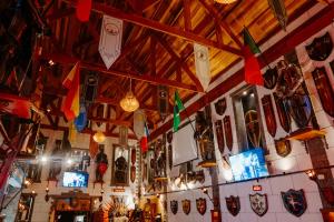 a room with a bunch of masks on the wall at Casarão da Ducha Hotel in Campos do Jordão