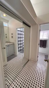 a bathroom with a shower and a glass door at Echo Park Hills in Los Angeles