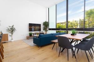 a living room with a blue couch and a table at Bright and Trendy - Panoramic - Chic - Prime Location in San Diego
