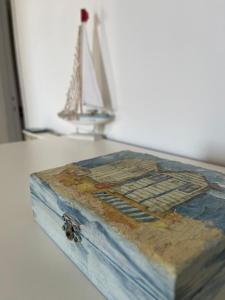 a book sitting on top of a table with a boat at A un passo dal mare! in Piombino