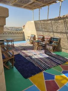 a room with colorful floors and tables and rugs at Nubian Heights in Aswan