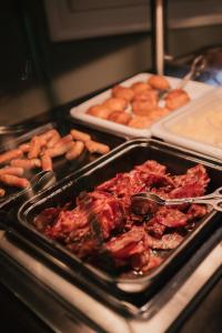 a tray of food with meat and pretzels and other foods at Kasteel De Vanenburg in Putten +54 photos
