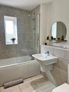 a bathroom with a sink and a shower and a tub at Chocolate Quarter Townhouse in Keynsham +18 photos