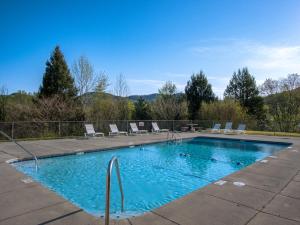 a swimming pool with lounge chairs at Townsend River Breeze Inn in Townsend