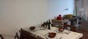 a dining room table with a white table cloth and a table at Al Sangallo Agriturismo in Montecarlo