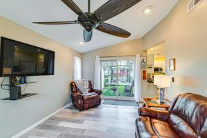 a living room with leather furniture and a flat screen tv at Pet-Friendly Honeoye Cottage Rental Walk to Lake! in Honeoye