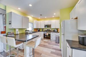 a kitchen with white cabinets and a black counter top at Pet-Friendly Honeoye Cottage Rental Walk to Lake! in Honeoye +18 photos