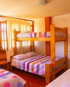 a bedroom with two bunk beds in a room at HOSPEDAJE SCHASCA in Oxapampa