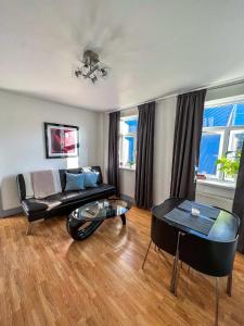 a living room with a couch and a table at Shoreditch London - Lovely Two-Bedroom Apartment in London