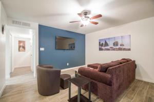 a living room with a couch and a ceiling fan at 34A Casa Grande Modern 1bd condo w HEATED POOL in Casa Grande