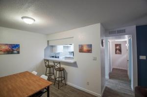 a kitchen and dining room with a table and a counter at 34A Casa Grande Modern 1bd condo w HEATED POOL in Casa Grande