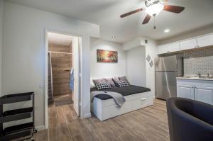 a bedroom with a bed with a ceiling fan at 34B- Modern studio condo heated pool and dog park in Casa Grande