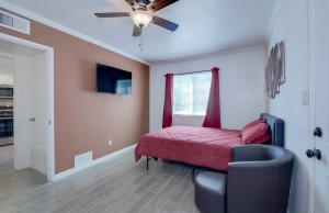 a bedroom with a red bed and a ceiling fan at 37B- Casa Grande Condo full remodel w HEATED POOL in Casa Grande