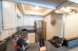 a kitchen with a sink and a refrigerator at 41A Modern Large Studio Condo w heated pool in Casa Grande