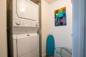 a washer and dryer in a room with a painting at 41A Modern Large Studio Condo w heated pool in Casa Grande
